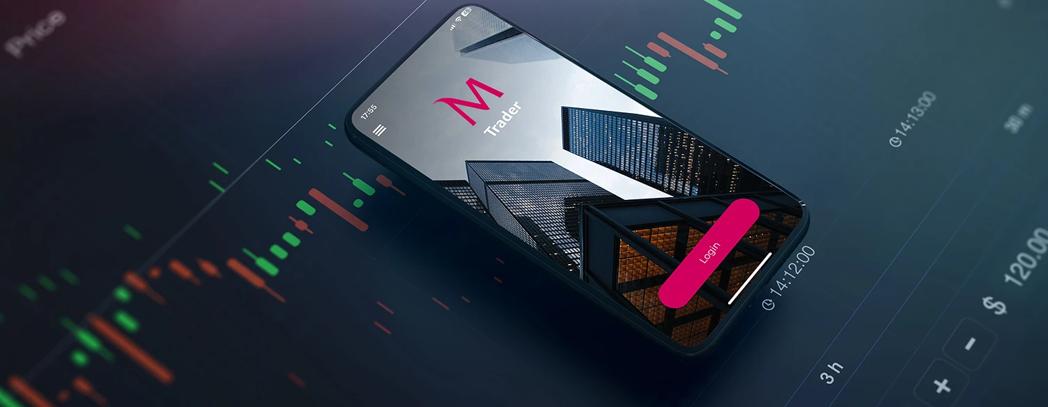 mobile phone showing the login screen of the MTrader app, on top of a stock market chart
