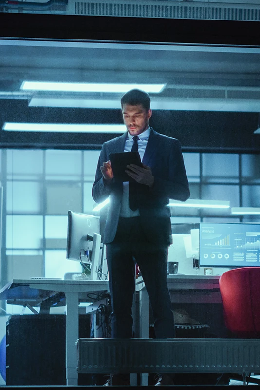 businessman, standing in office, with tablet