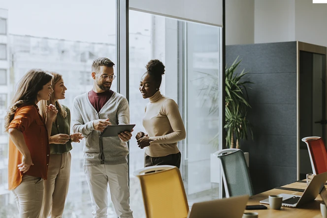 4 people in a meeting in an office
