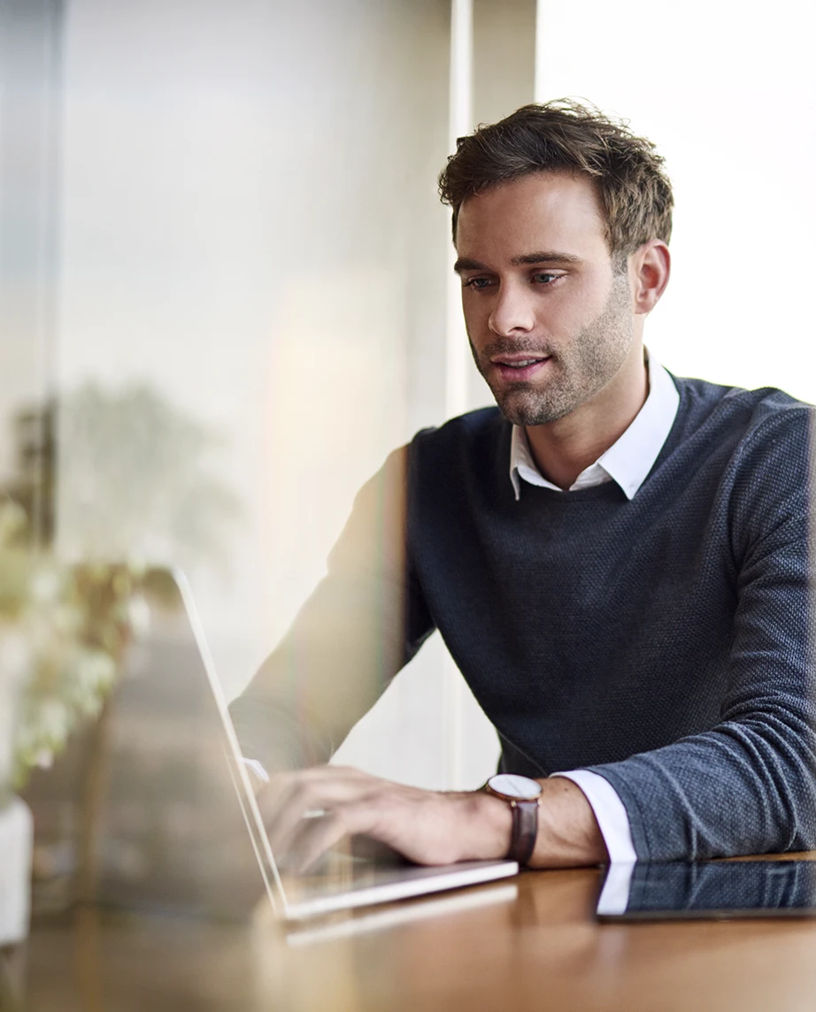 Man sitting in an office, working on a computer