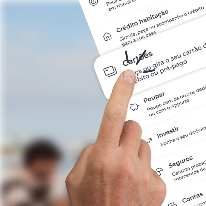 Dedo indicador a clicar numa das entradas de uma lista de produtos bancários, nomeadamente na que diz "Cartões"