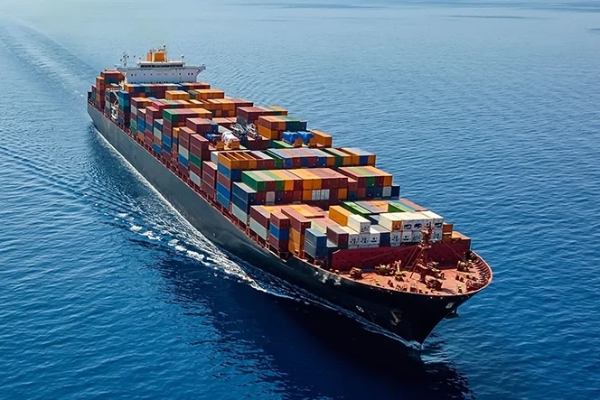 Large container ship sailing on the open sea under a clear sky