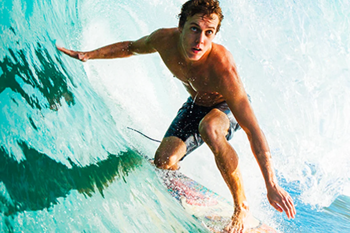 young man surfing a wave