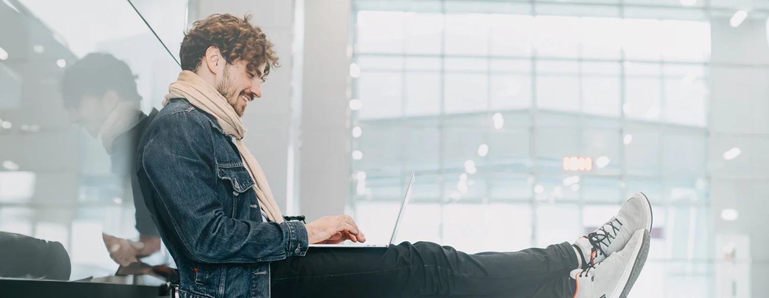 young man sitting on the floor, with laptop