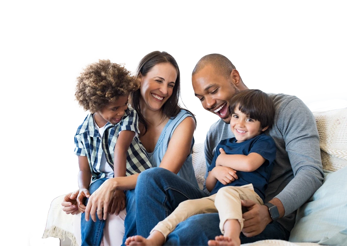  father, mother, and 2 children, sitting on the sofa, smiling