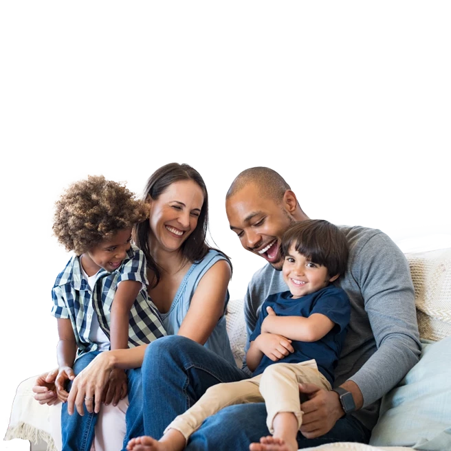  father, mother, and 2 children, sitting on the sofa, smiling