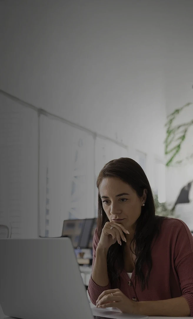 Woman concentrating while working on a laptop