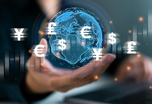 Hand holding a digital globe with various currency symbols around it