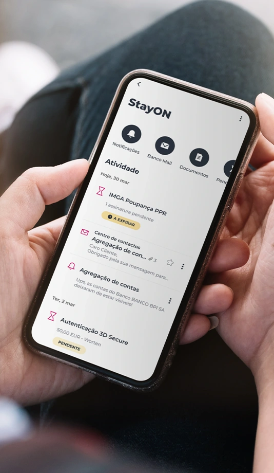 Hands holding a phone with the StayON area screen in the Millennium app