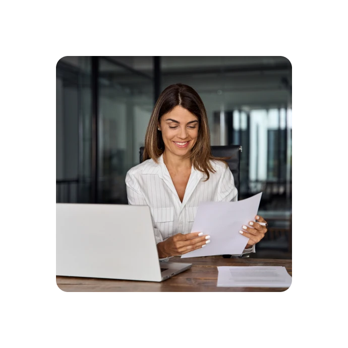 woman smilling while reading documents