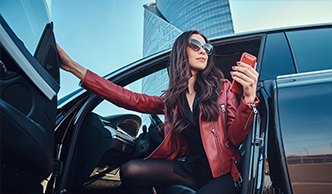 woman in sunglasses, getting out of her car