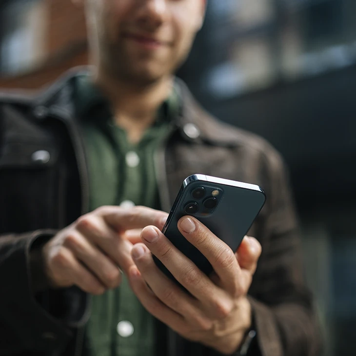 Man using a smartphone outdoors