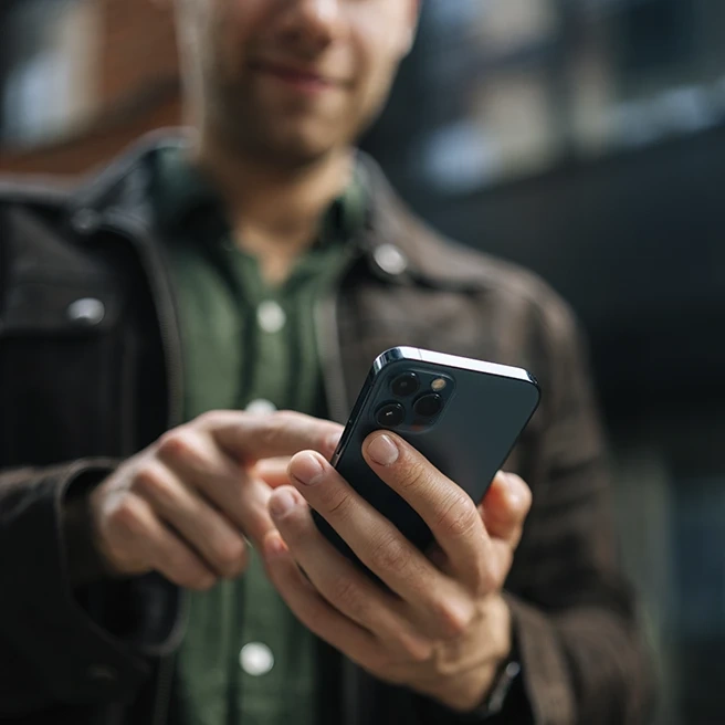 Man using a smartphone outdoors