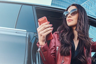 woman in sunglasses, getting out of her car