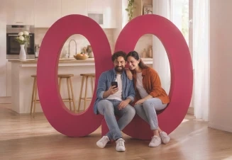 Casal sentado no logótipo do Millennium na sala de uma casa moderna