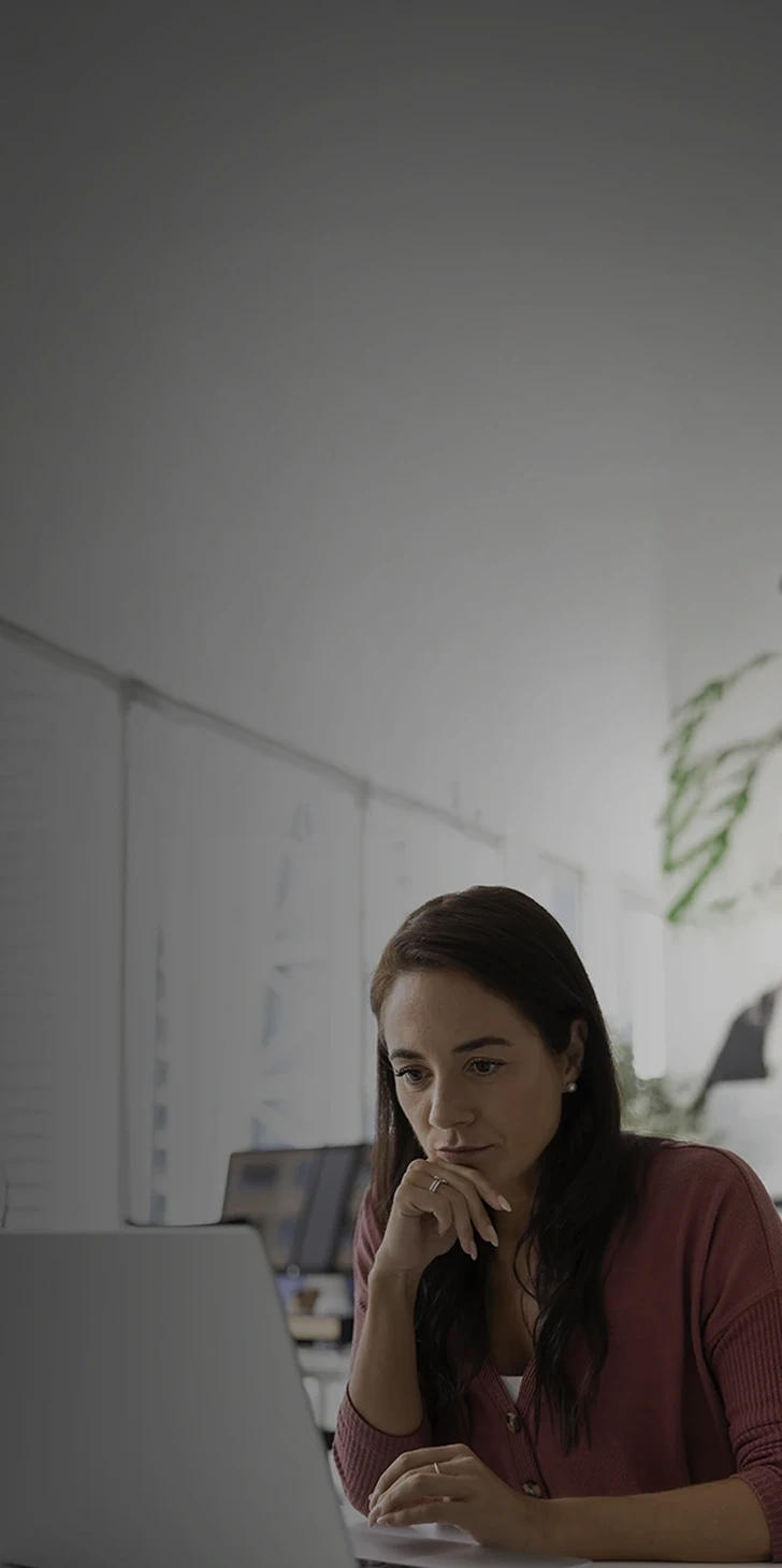 Woman concentrating while working on a laptop