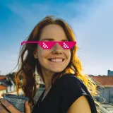 Smiling girl with pink pixelated glasses