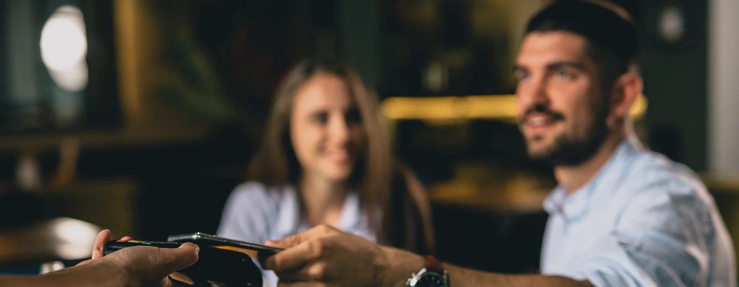 man paying with his phone