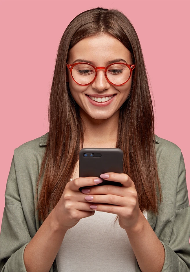 young girl checking her phone and smiling