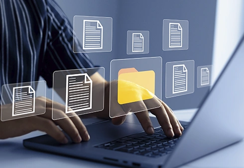 Person organising digital files and folders on a laptop