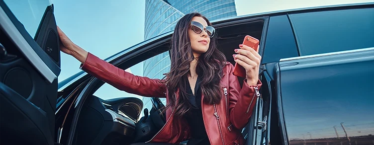 woman in sunglasses, getting out of her car