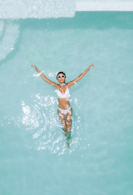 woman peacefully floating in a pool