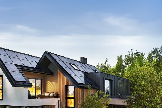 house with solar panels, surrounded by trees