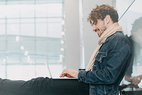 young man sitting on the floor, with laptop