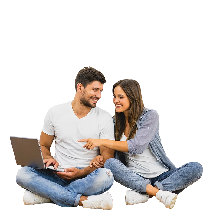 couple sitting cross-legged with a laptop