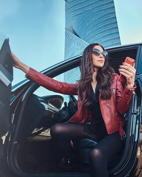 woman in sunglasses, getting out of her car