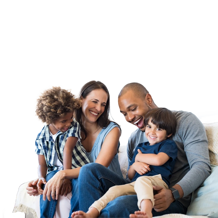  father, mother, and 2 children, sitting on the sofa, smiling