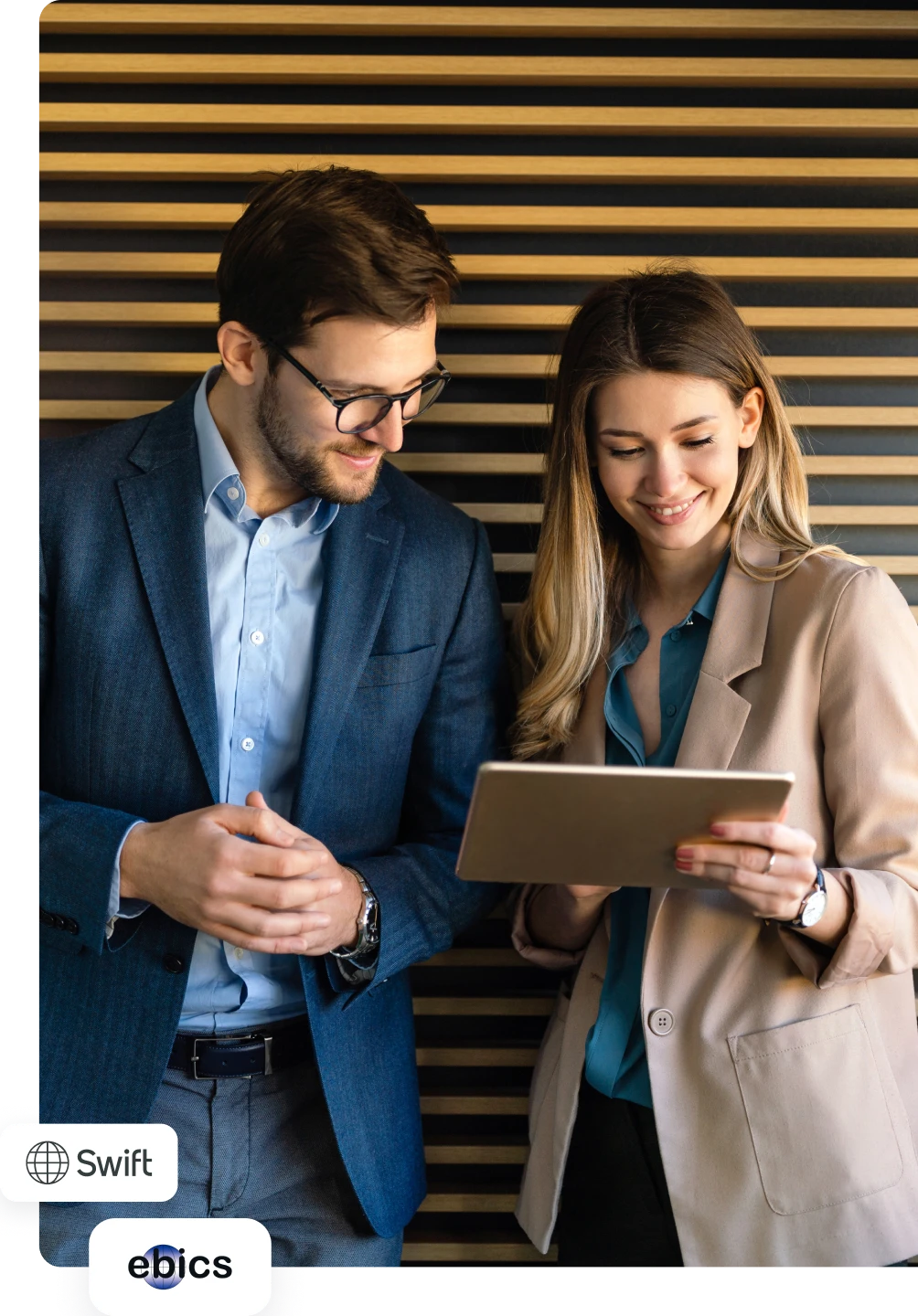 Dois profissionais analisam informação num tablet num ambiente corporativo moderno