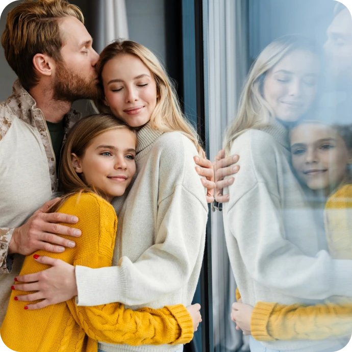 couple and daughter in a hug
