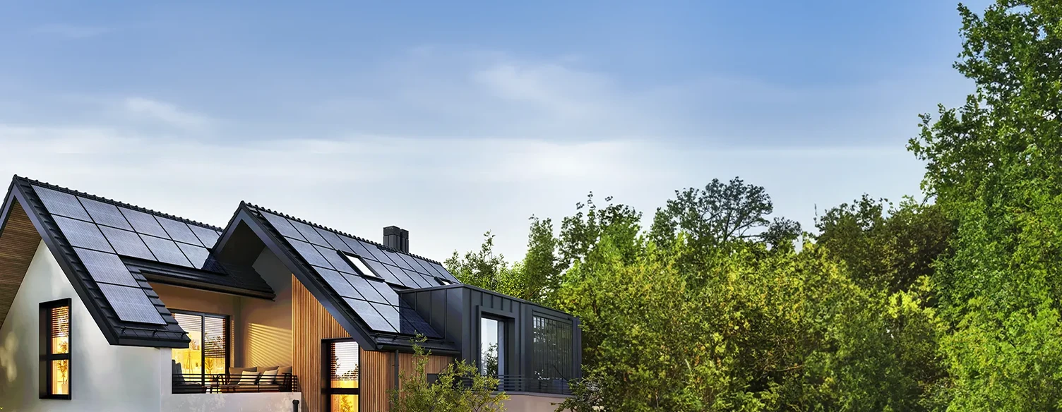 house with solar panels, surrounded by trees