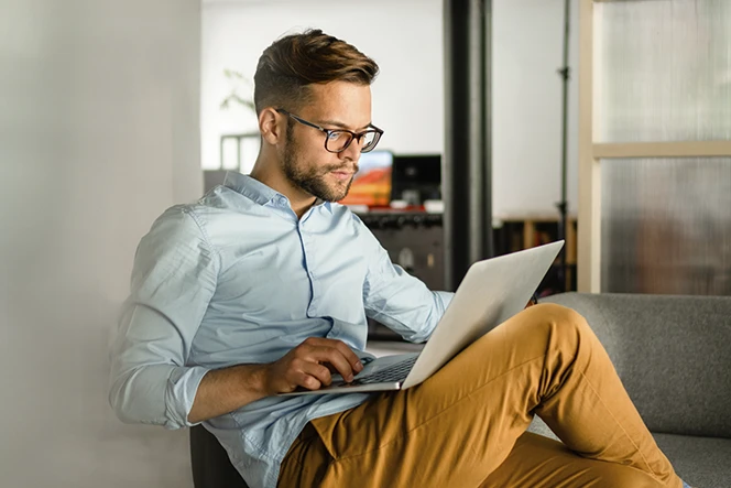 Man sitting on a sofa with a computer