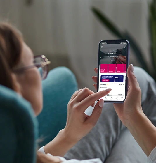 woman holding a phone with the Millennium app screen