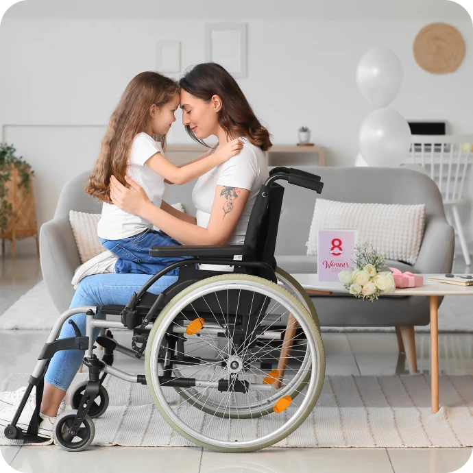 mother in a wheelchair holding her daughter on her lap
