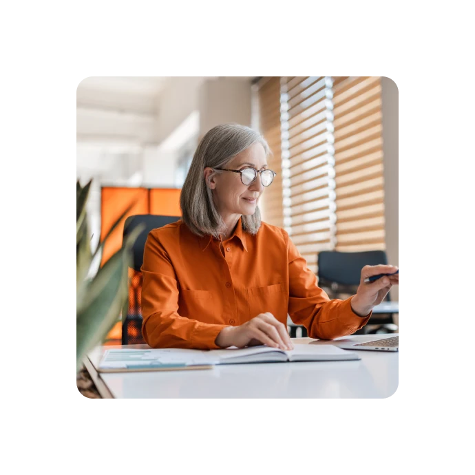 woman smilling while looking at laptop