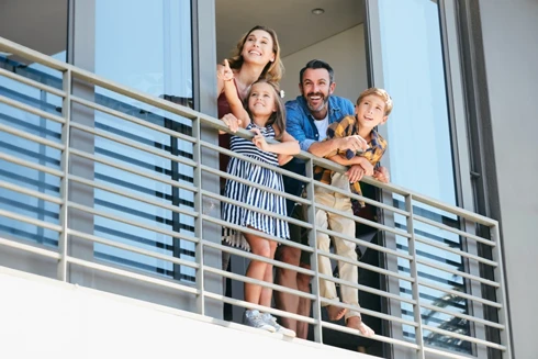 couple and 2 kids, at their home balcony