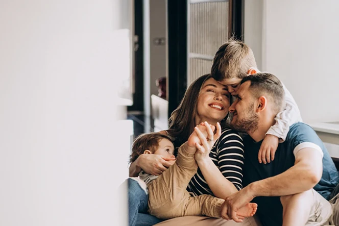 casal com 2 filhos pequenos, num abraço